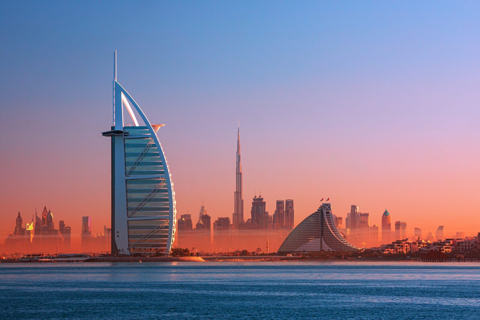 Dubai city - amazing city center skyline and famous Jumeirah beach at sunset, United Arab Emirates