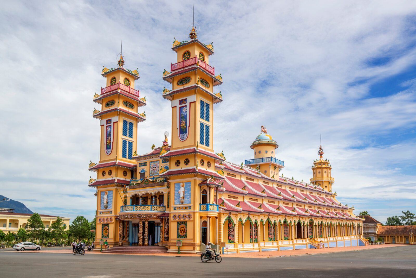 Cao Dai temple area and meditating followers of the Cao Dai religion in the temple Cao Dai, Tay Ninh, Vietnam