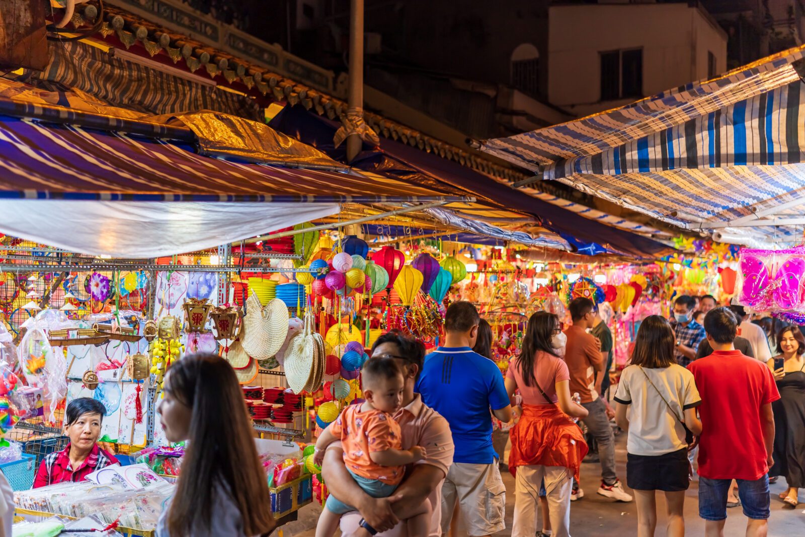 People visit and buy colorful traditional lanterns hanging on Luong Nhu Hoc Street in Vietnam